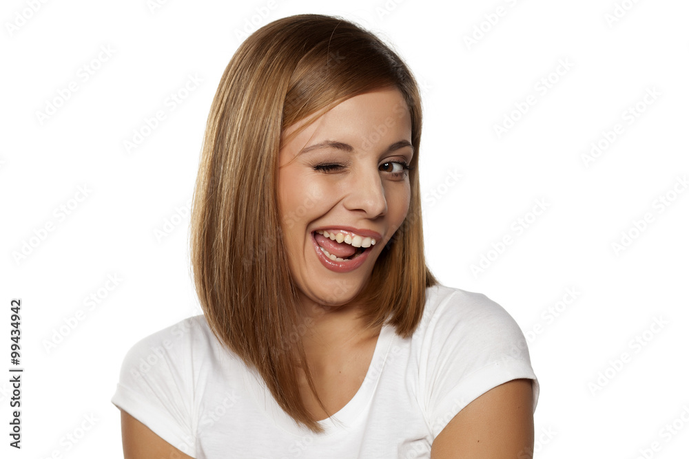happy young woman winking on a white background happy young woman winking on a white background