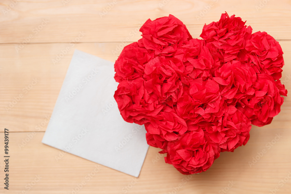 Handmaid flowers in box with valentine card on brown backdrop Handmaid flowers in box with valentine card on brown backdrop