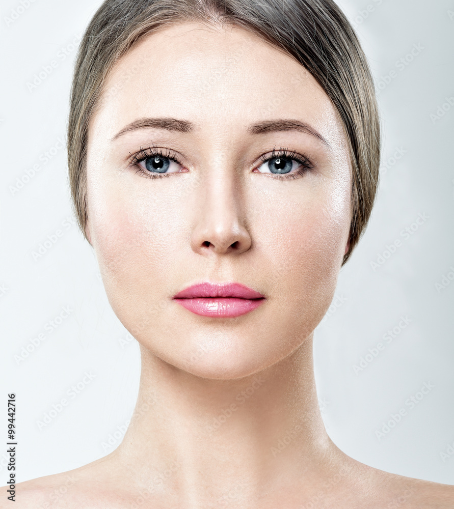 Beautiful face of young adult woman with clean fresh skin. Looki Beautiful face of young adult woman with clean fresh skin. Looki