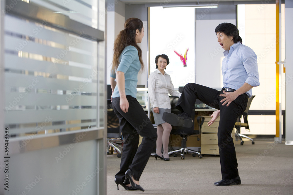 Office workers kick a shuttlecock around on break Office workers kick a shuttlecock around on break
