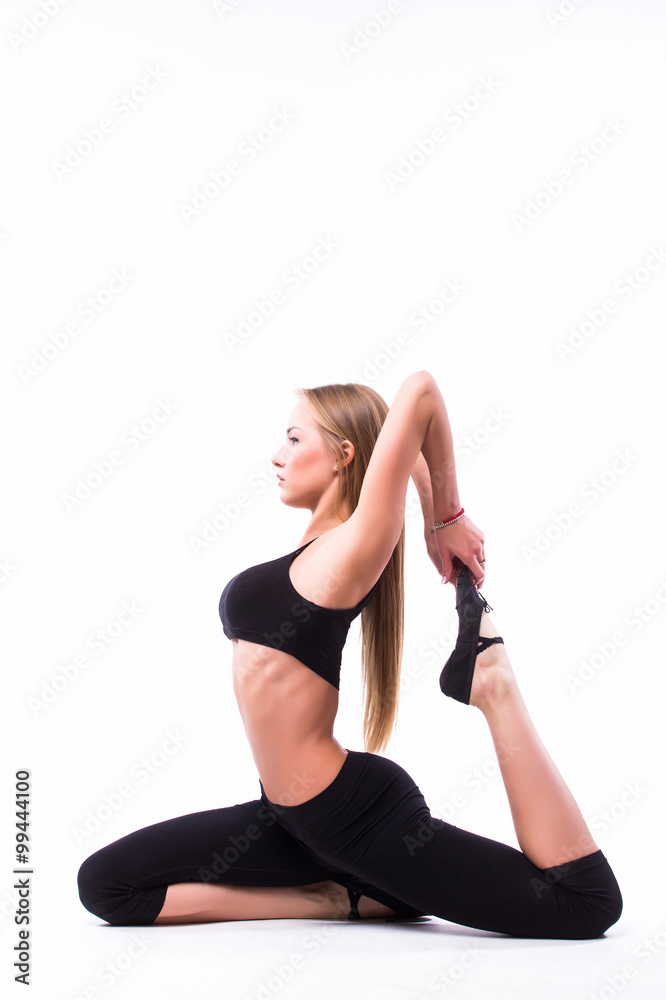 Young woman doing gymnastic exercise on white isolated background