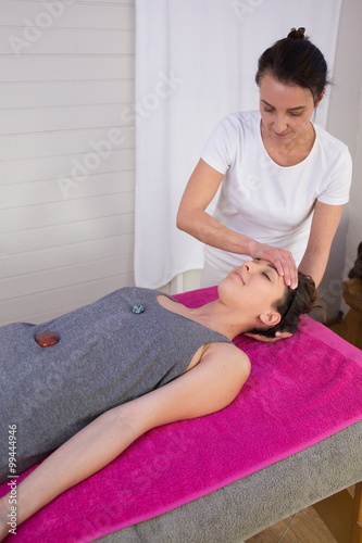 Young woman relaxing during bioenergy therapy session photo