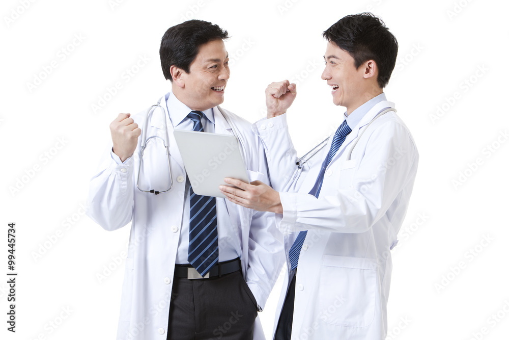 Male doctors punching the air with digital tablet in hand Male doctors punching the air with digital tablet in hand