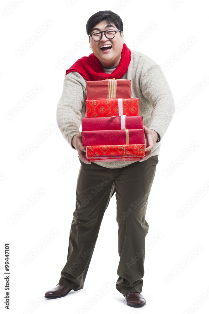 Cheerful young man with Chinese New Year's gifts Cheerful young man with Chinese New Year's gifts