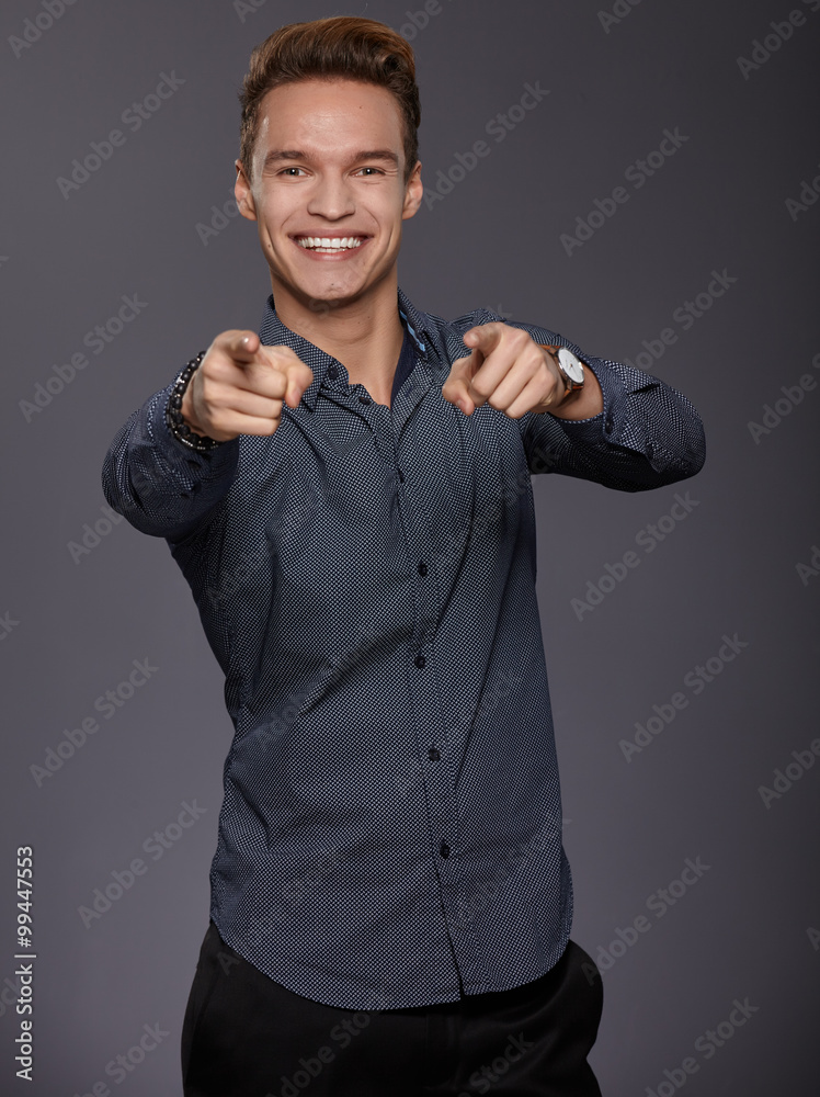 Happy smiling young man looking at camera with satisfaction isol Happy smiling young man looking at camera with satisfaction isol