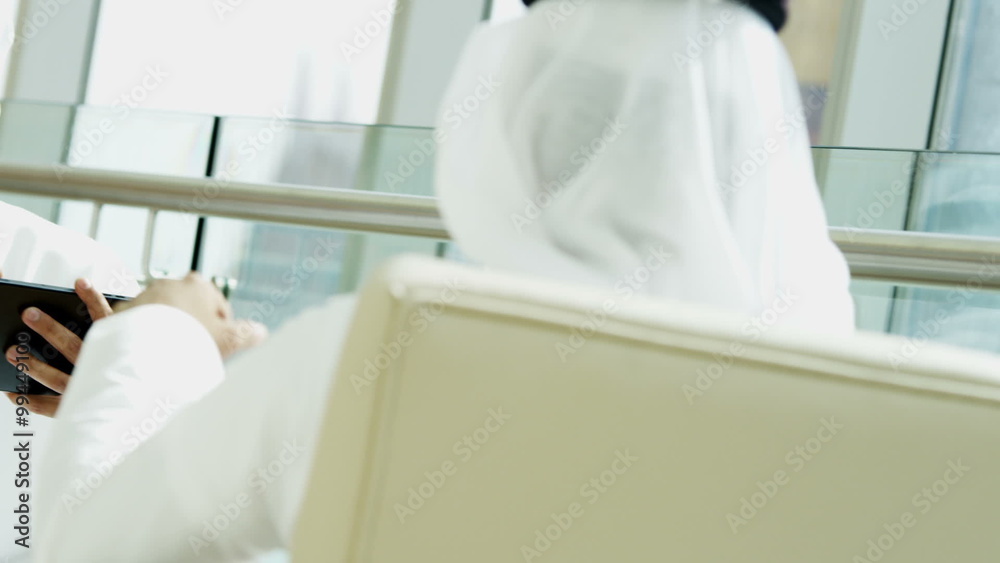 Arab business male kandura tablet technology property construction handshake Arab business male kandura tablet technology property construction handshake