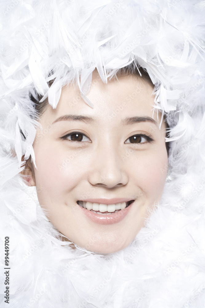 Feathers surrounding the face of young woman