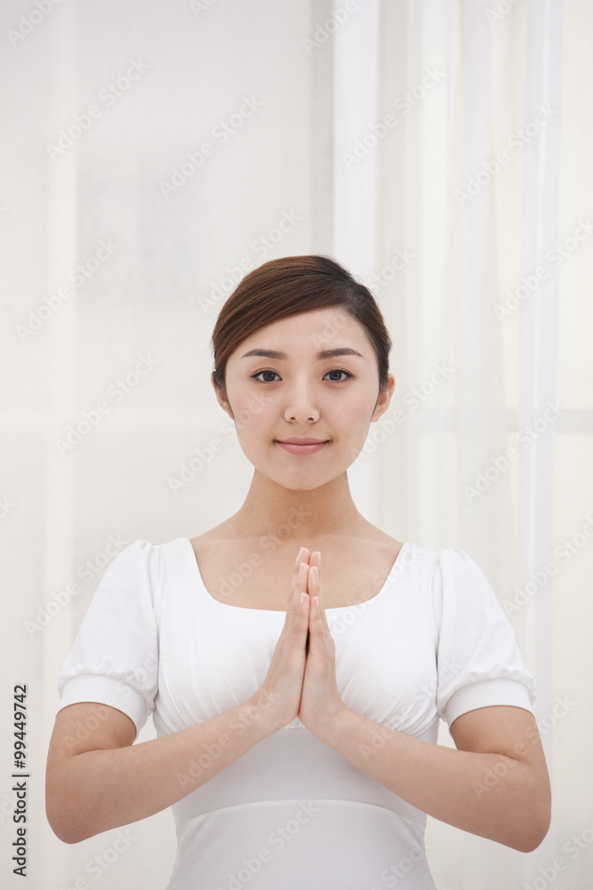 Young woman with hands together Young woman with hands together