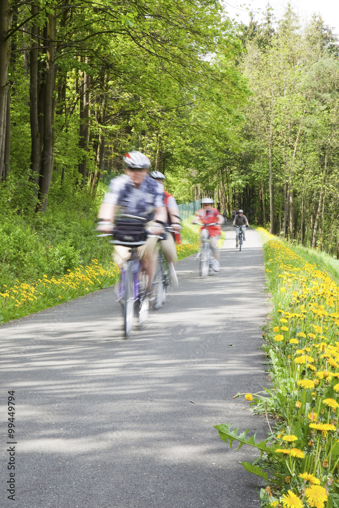 Naklejka premium People cycling through countryside