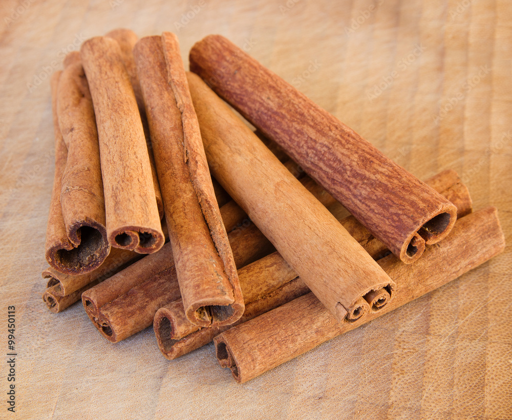 Heap of the cinnamon sticks on the wooden background Heap of the cinnamon sticks on the wooden background