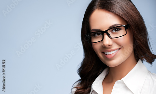 young brunette businesswoman in glasses, over grey