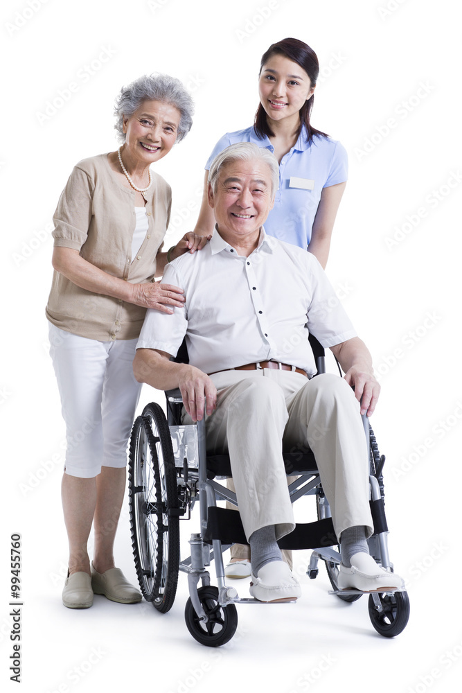 Wheelchair bound man with his wife and nursing assistant Wheelchair bound man with his wife and nursing assistant