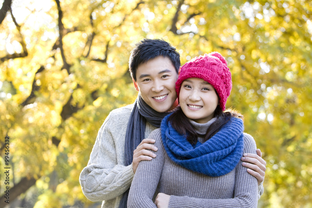 Young Couple Enjoying a Park in Autumn Young Couple Enjoying a Park in Autumn