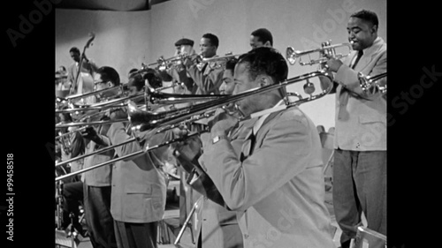 Side view of brass section of band performing, 1950s