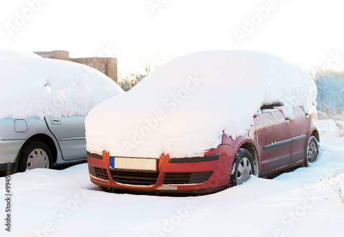 Cars covered with snow in the winter.