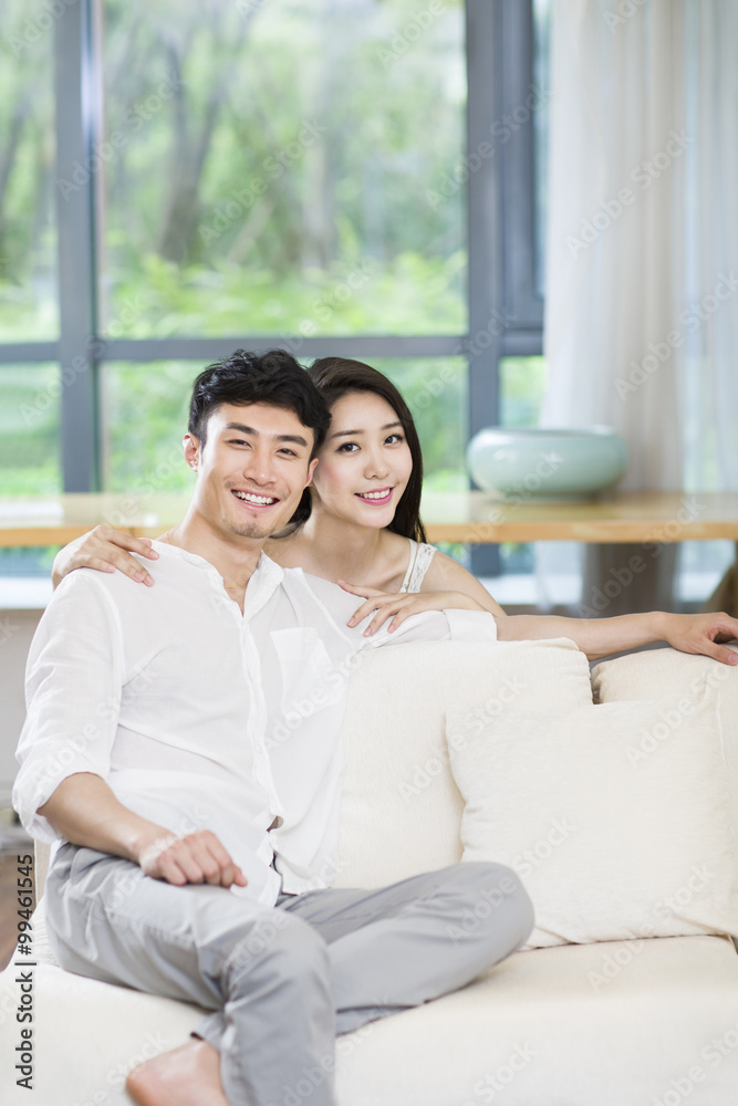 Cheerful young couple in living room