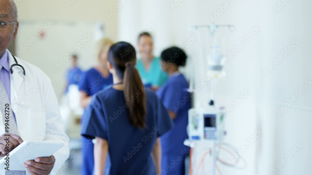 African American male doctor working on tablet technology in medical center