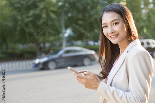 Young woman holding a smart phone