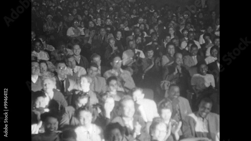 Spotlight panning audience in theater from right to left, 1950s