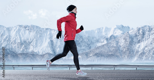 female Runner in winter mountain surrounding