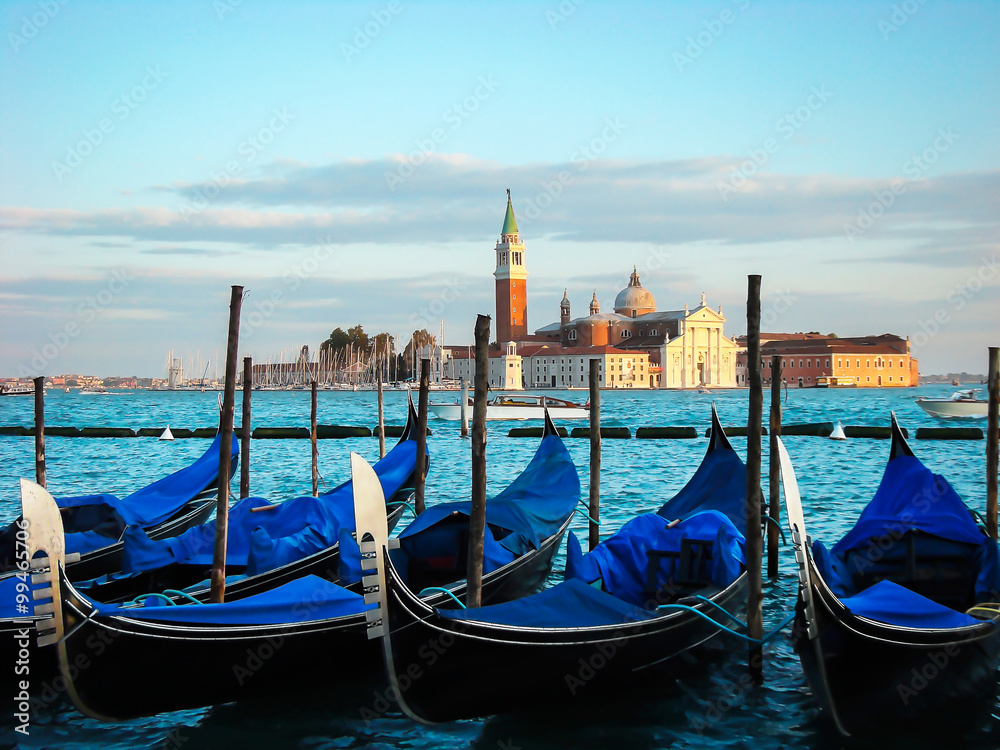 Gondolas moored by Saint Mark square. View of the San Giorgio di Maggiore from Piazza San Marco - Venice, Venezia, Italy, Europe 