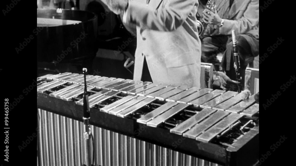 Medium shot of energetic musician playing xylophone, 1950s