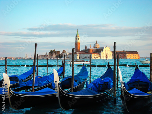 Gondolas moored by Saint Mark square. View of the San Giorgio di Maggiore from Piazza San Marco - Venice, Venezia, Italy, Europe  © TasiPas