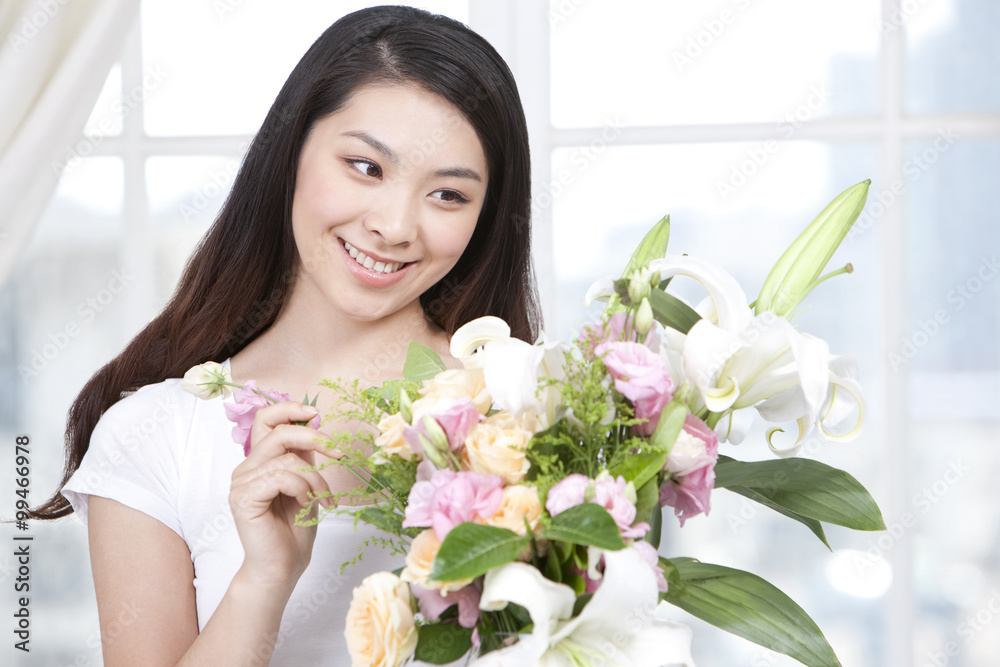 Young woman arranging flowers Young woman arranging flowers