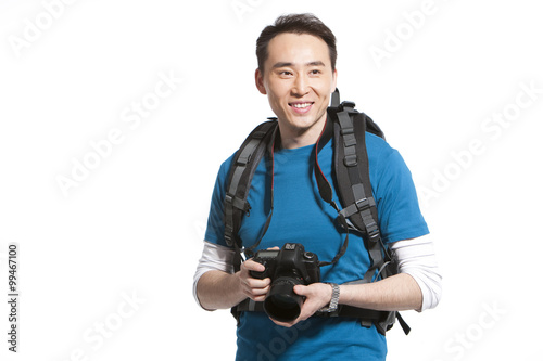 Portrait of a young man holding a camera