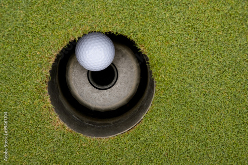 Close-up of golf ball in hole