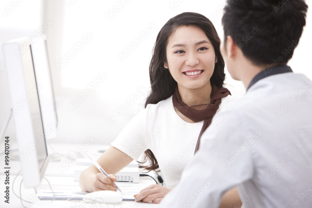Happy business coworkers talking in the office Happy business coworkers talking in the office