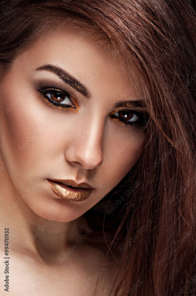 Obraz premium Close up Art beauty portrait. Fashion gold make up of beautiful