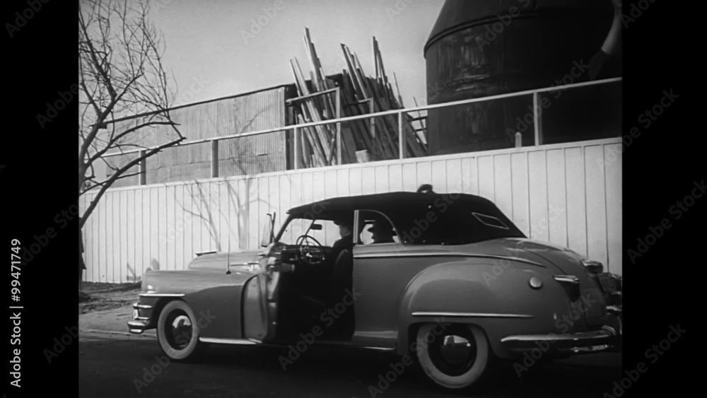 Man getting into car, 1940s