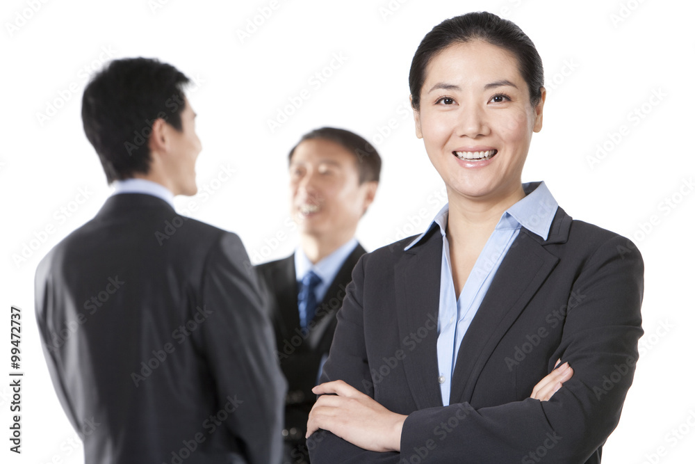 Businesswoman with business partners in background Businesswoman with business partners in background