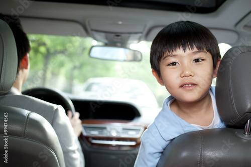 Father driving with son in front seat © Blue Jean Images