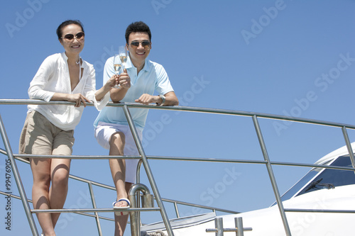Toasting Champagne on a Yacht © Blue Jean Images