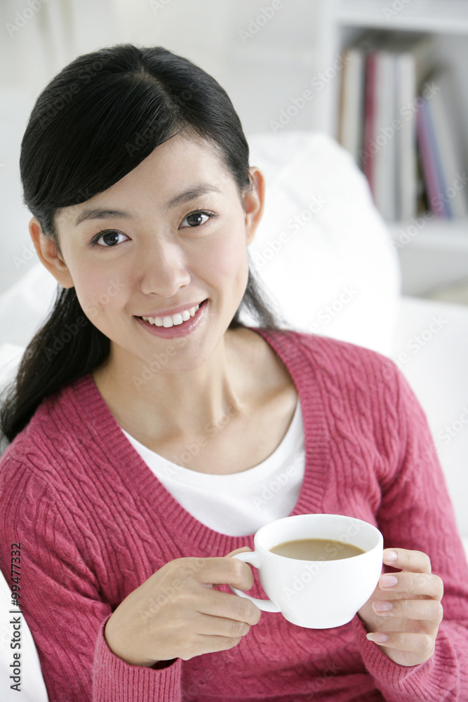Young Chinese woman with a cup of coffee Young Chinese woman with a cup of coffee