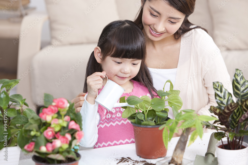 Happy mother and daughter with potted plants