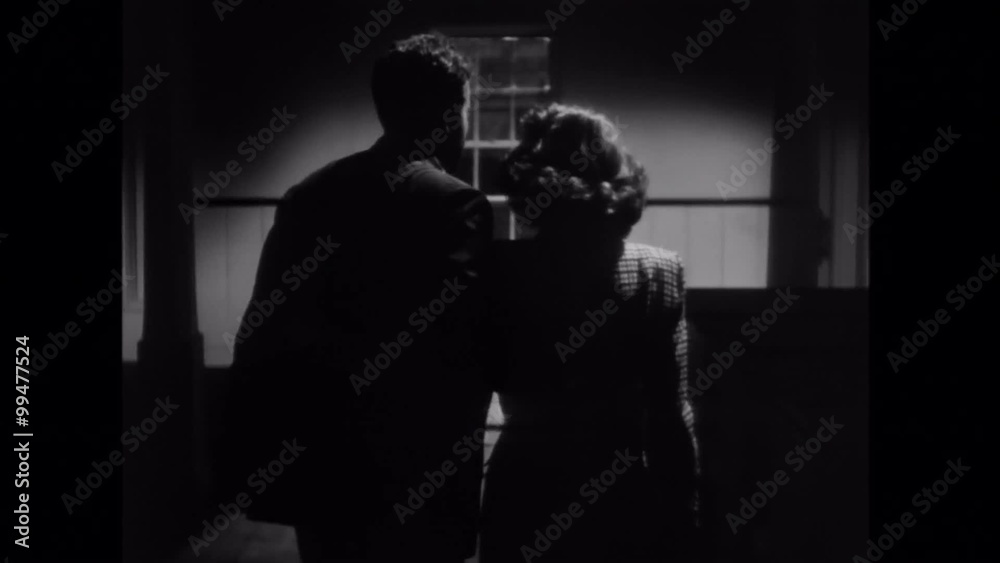 Rear view of couple walking in house