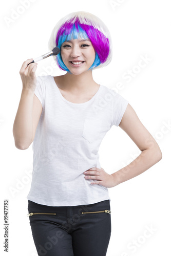 Young woman putting on make up