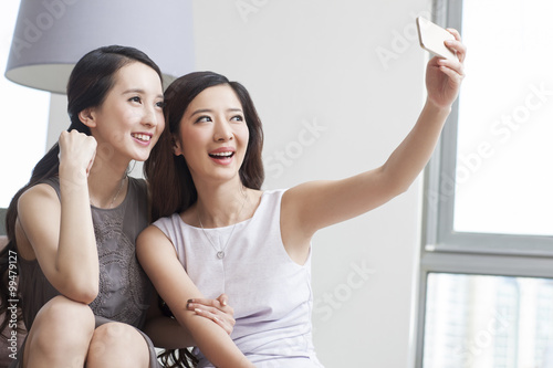 Young women taking self portrait with smart phone