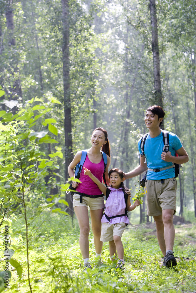 Girl hiking with her parents Girl hiking with her parents