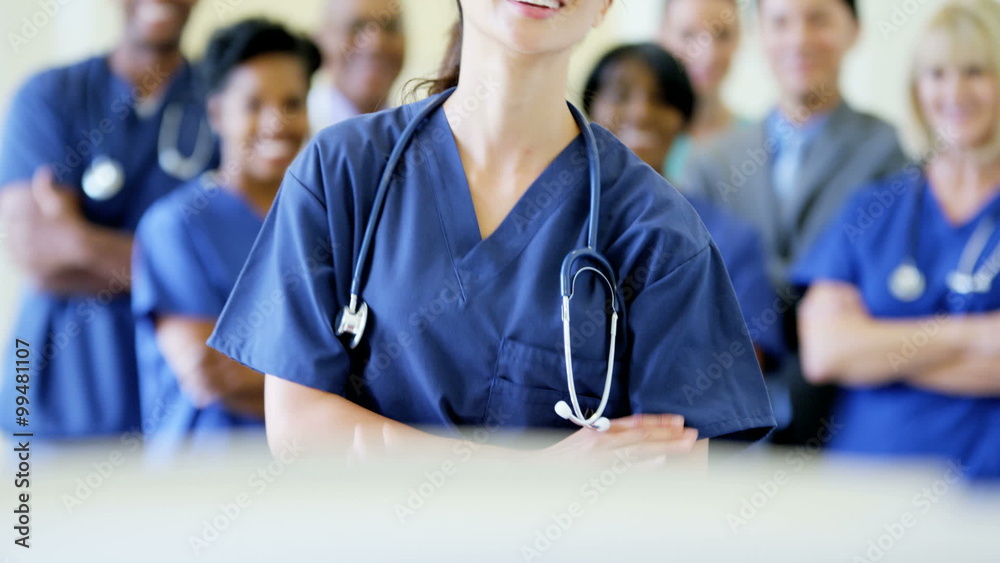 Portrait of confident Chinese Asian female nurse and team of staff in hospital