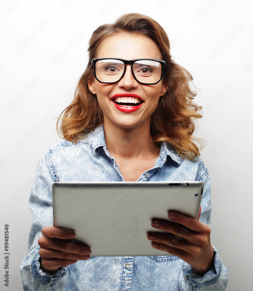 happy teenage girl wearing glasses with tablet pc computer