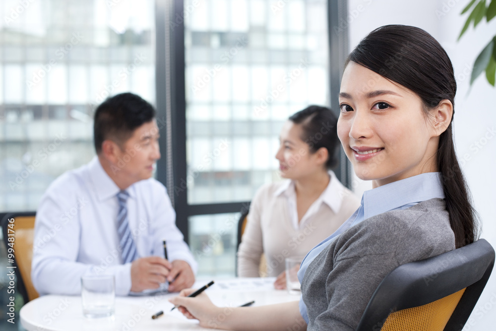 Businesswoman at a meeting with colleagues Businesswoman at a meeting with colleagues