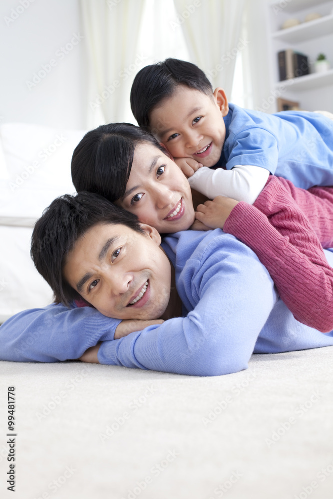 Young Chinese family lying on the floor close-up Young Chinese family lying on the floor close-up