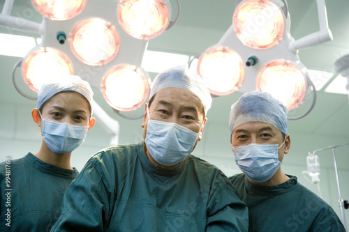 Portrait of three happy surgeons