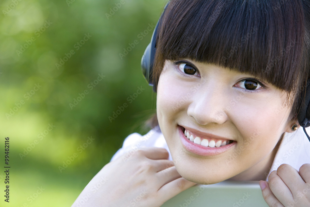Woman in park with headset Woman in park with headset