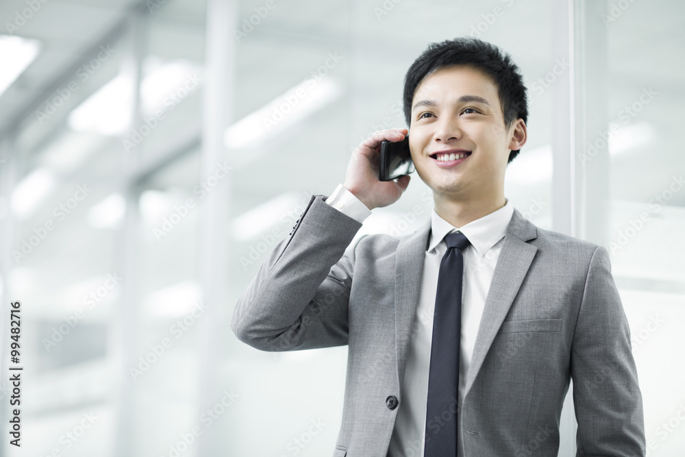 Young businessman talking on the phone Young businessman talking on the phone