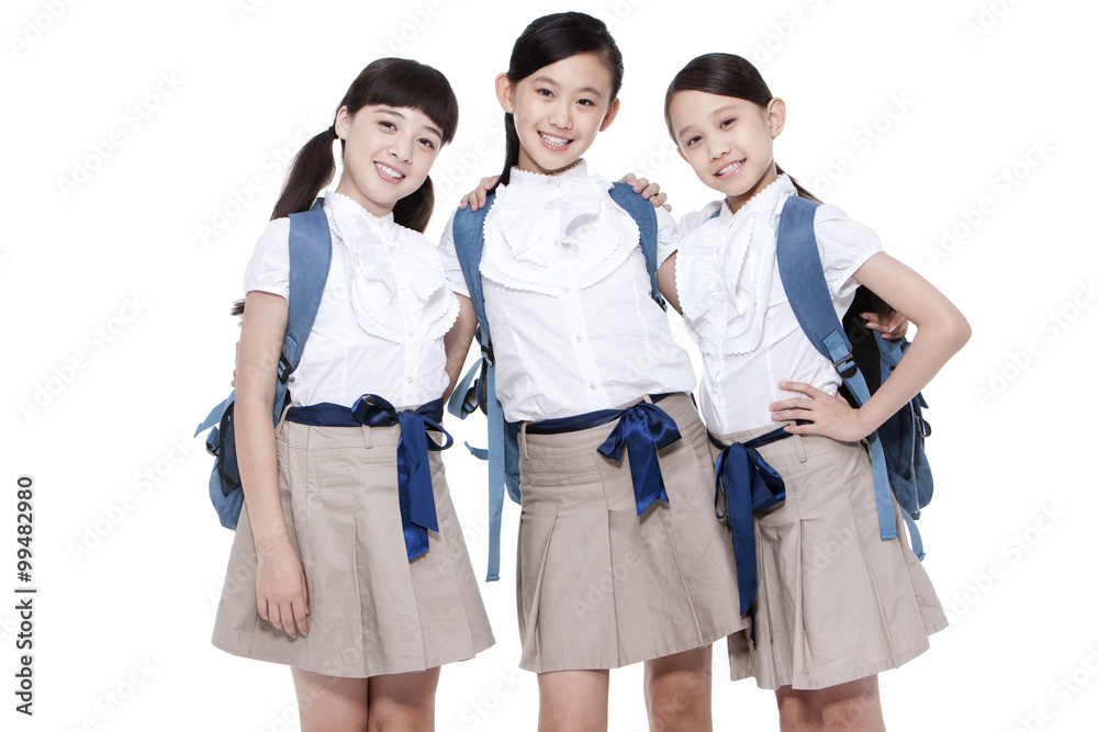 Close schoolgirls side by side smiling with schoolbag on the back Close schoolgirls side by side smiling with schoolbag on the back